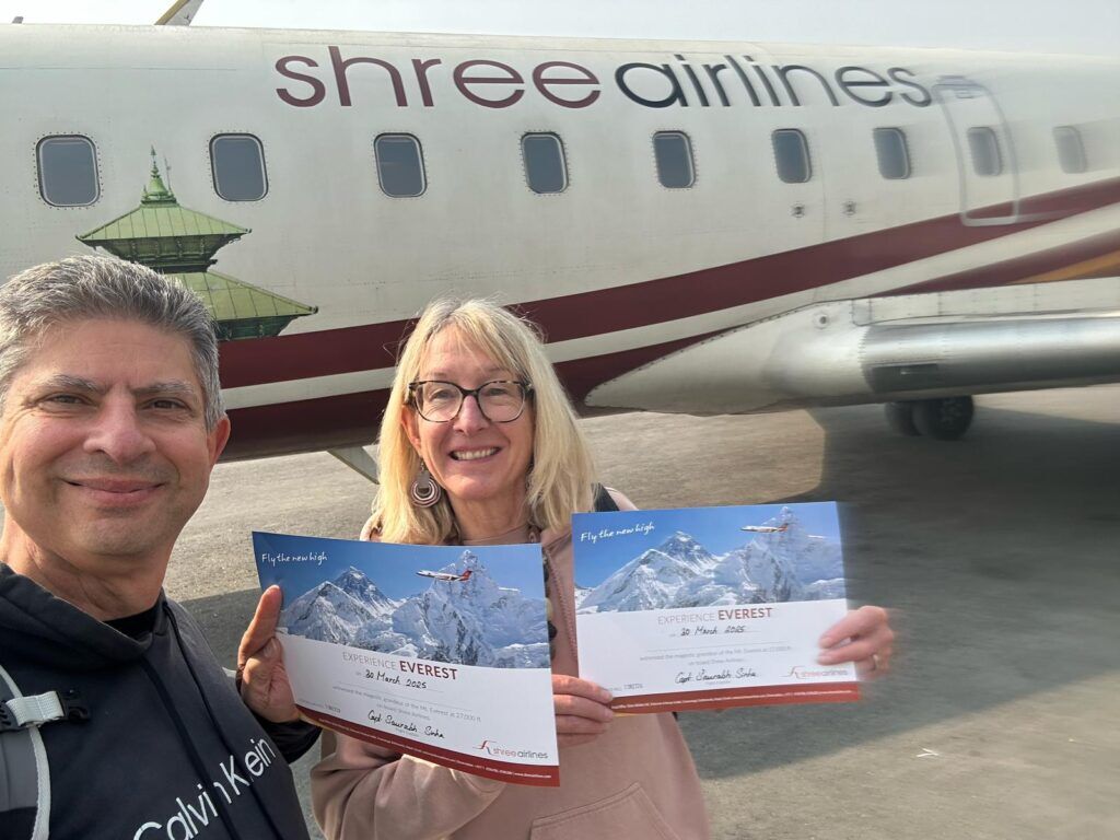 customer with certificate after completing their Everest scenic mountain flight