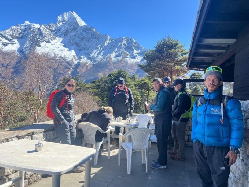 Trekkers enjoying a tea break with Himalayan mountain views on the Everest Base Camp Trek in Nepal