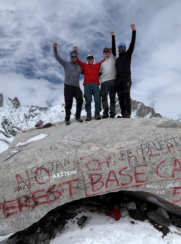 A trekker on the Everest Base Camp trail in December with a clear blue sky.