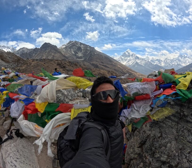 fluttering prayer flags with chill breeze and stunning mountain peaks