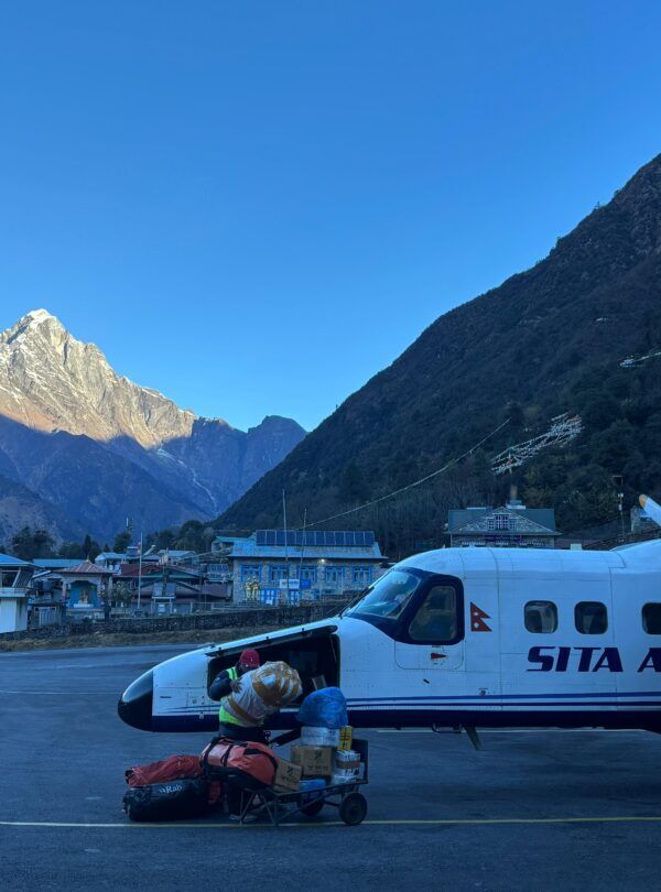 Lukla Airport mountain flight with Sita Air aircraft loading supplies on Everest Base Camp Trek route